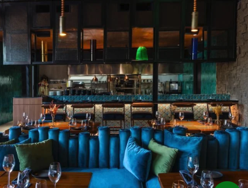 Moody interior of Jade restaurant with a blue-lit bar in Berawa, Canggu