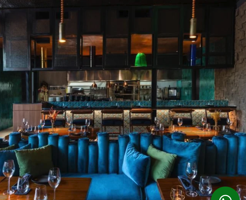 Moody interior of Jade restaurant with a blue-lit bar in Berawa, Canggu