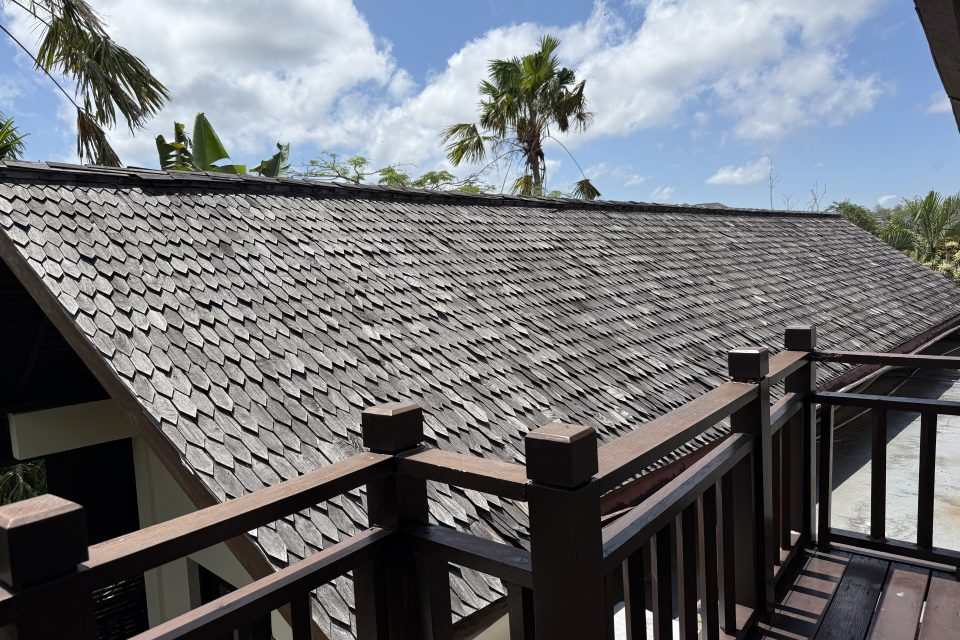Tiled villa roof and palm trees during renovation works at Karma Kandara, Ungasan